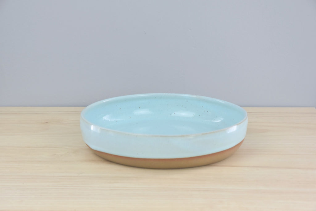 Handmade pottery - ceramic coup style plate - made in Winchester, KY by Dirty South Pottery. Pale turquoise blue glaze with speckles.
