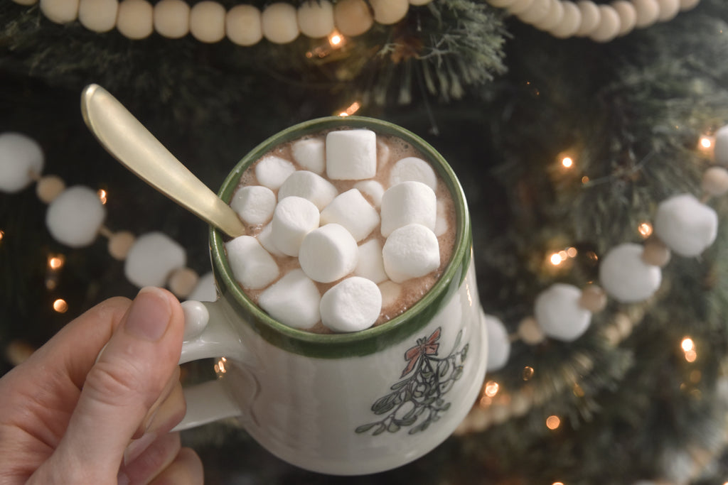 Handmade ceramic Christmas Mug with classic Mistletoe design, red bow, and green rim. 