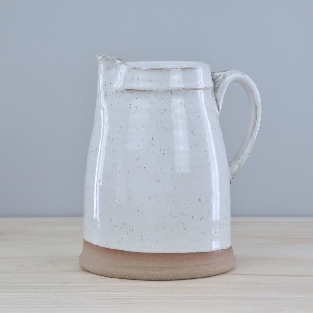 Handmade Pitcher from Dirty South Pottery in Winchester, KY - just outside of Lexington, Kentucky. White Glaze with speckles on dark clay.