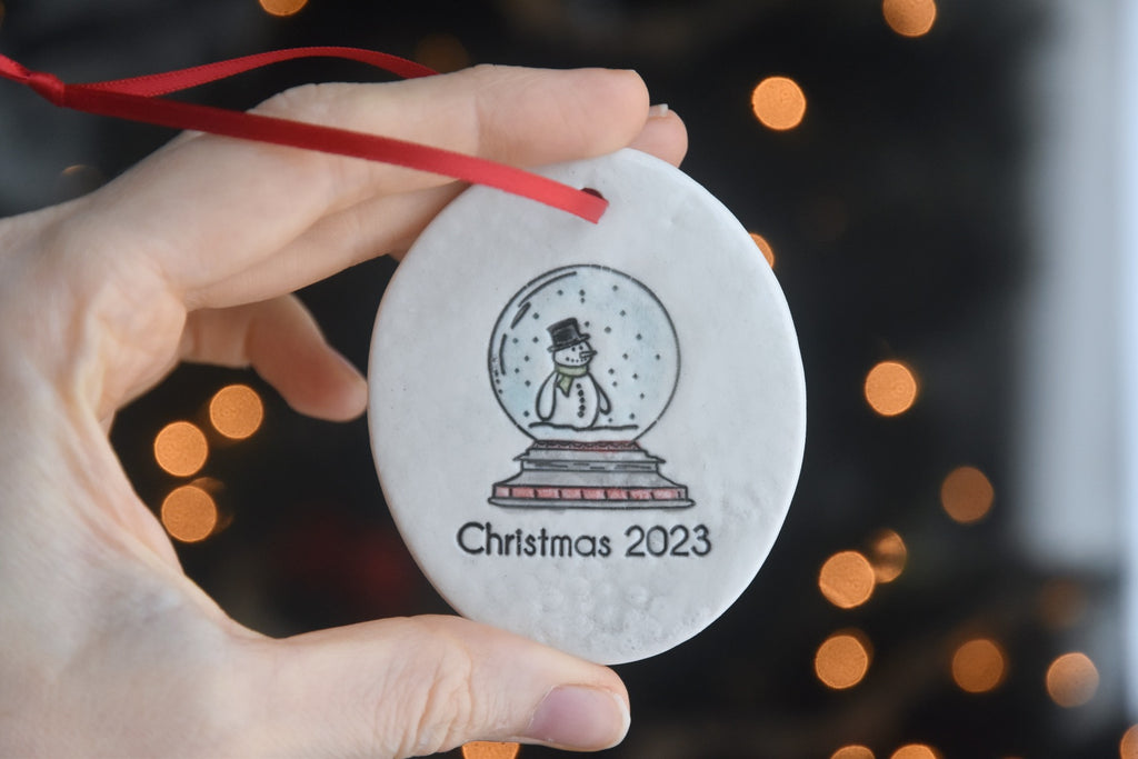 Handmade Ceramic Christmas Tree Ornament with a Snowman in a Snow Globe - 2023 Porcelain Ornament - copyright Dirty South Pottery