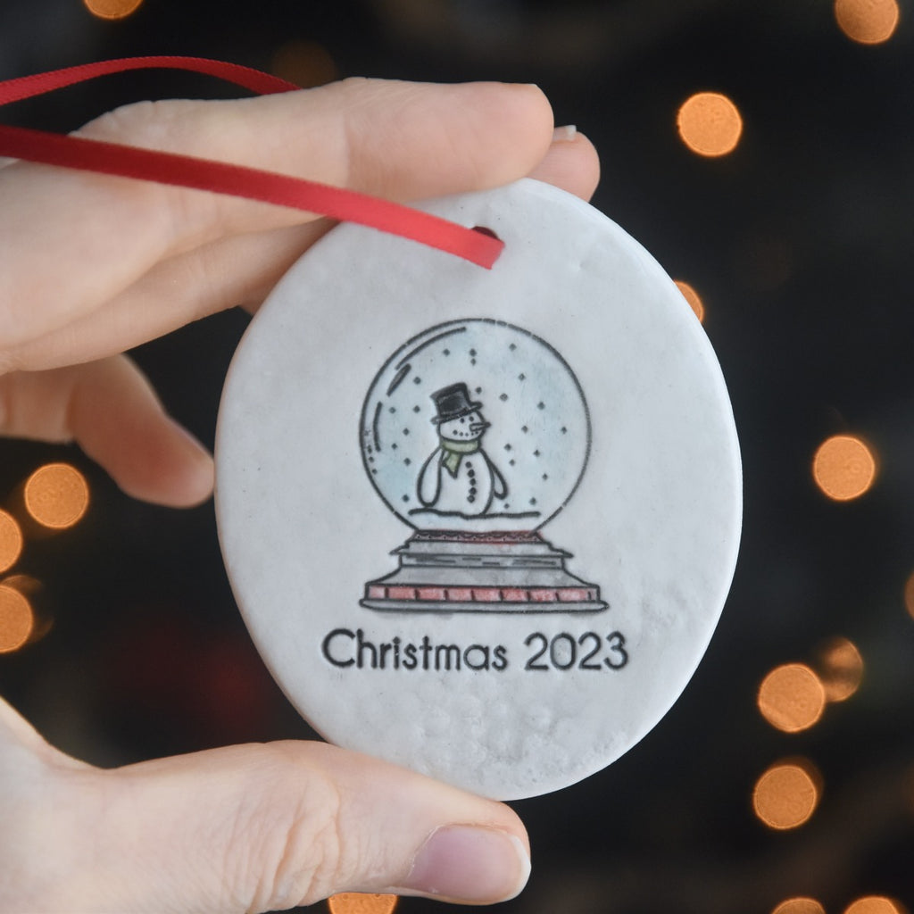 Handmade Ceramic Christmas Tree Ornament with a Snowman in a Snow Globe - 2023 Porcelain Ornament - copyright Dirty South Pottery