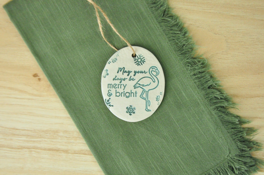 Round ornaments with 'May your days be Merry and Bright' next to a flamingo - beach, seaside, tropical ornament