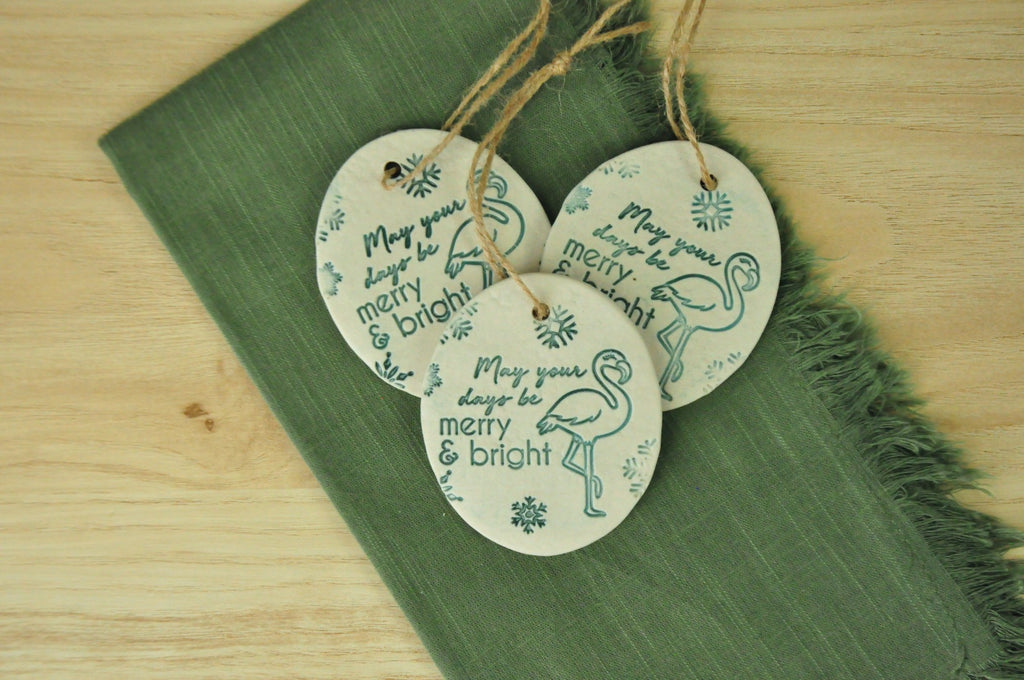 Round ornaments with 'May your days be Merry and Bright' next to a flamingo - beach, seaside, tropical ornament