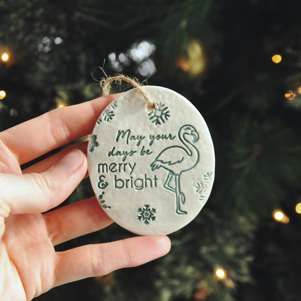 Round ornaments with 'May your days be Merry and Bright' next to a flamingo - beach, seaside, tropical ornament