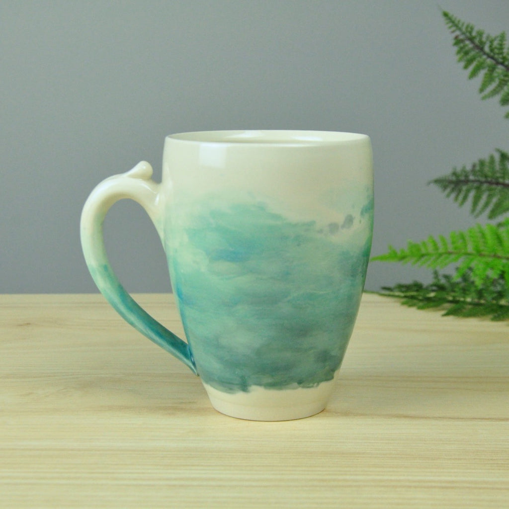 Larger Watercolor Mug - Coastal Blues blend into the handmade porcelain mug. Made in Winchester, KY